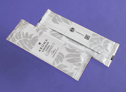 Front and back of the silver Xceed Towels refresher towel on purple background