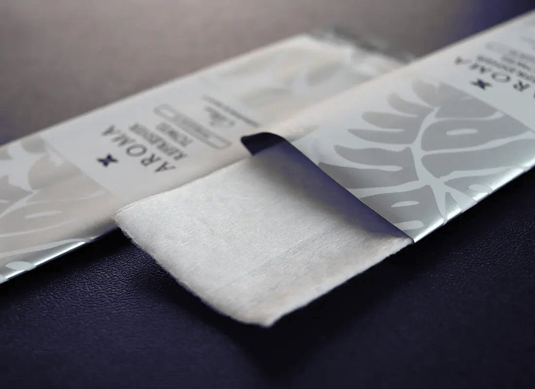Silver Xceed Towels refresher towel on black background with package open