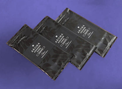 3 Aroma 60 Black Xceed Towels refresher towels on purple background