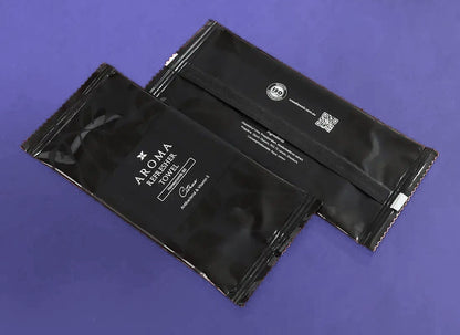 Aroma 60 Black Xceed Towels refresher towel on purple background, back and front