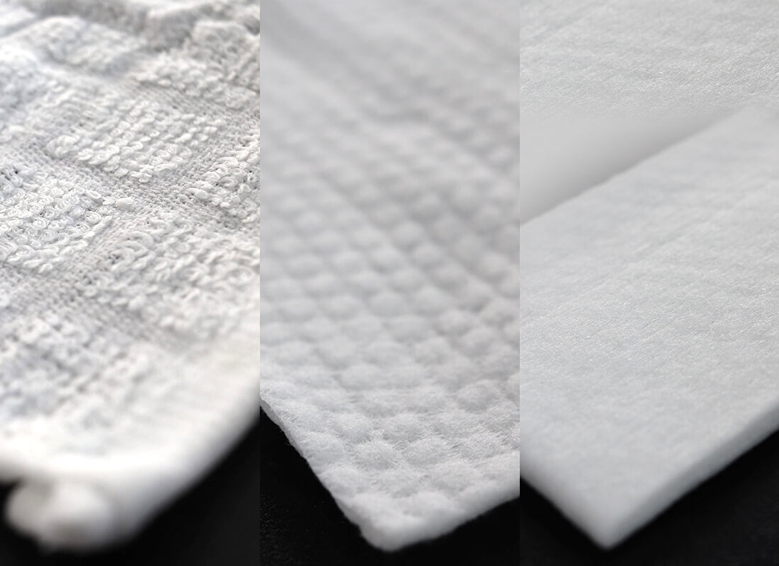 Close-ups of cotton, embossed and plain towel material side by side