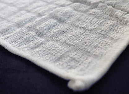 Close up of the Cotton Premier 15 towel's cotton weave and hemmed edge