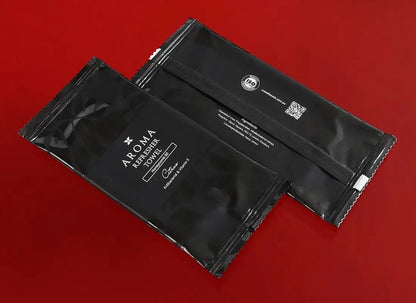 Aroma 60 Black Xceed Towels refresher towel on red background back and front images