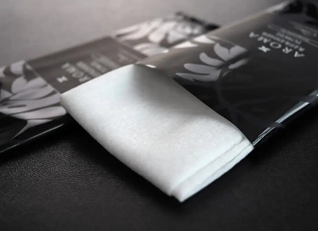  Aroma 60 Black Xceed Towels refresher towel on black background with package open